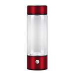 Clear glass bottle with red base and cap on a white background