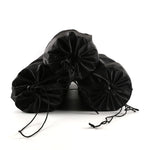 Three black velvet drawstring bags on a white background