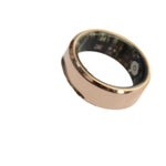 Gold smart ring on a white background